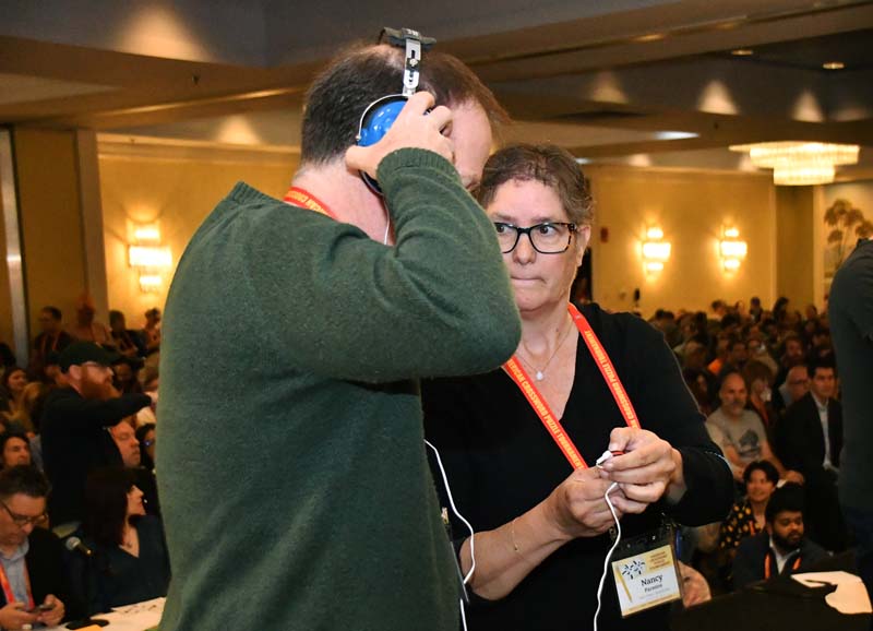 Nancy Parsons Adjusts David's Headset