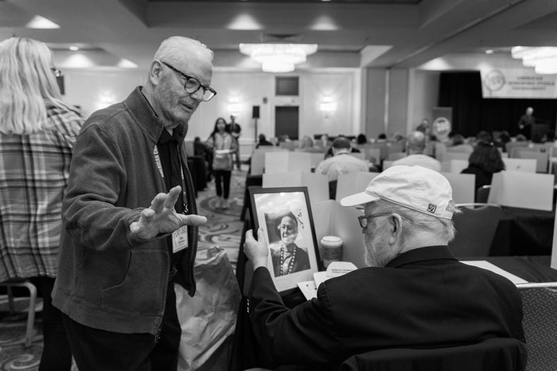 Don Christensen presents Bill Cash with a photo and a story